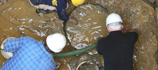 Archaeologists excavating a well