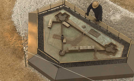 Aerial view of archaeologist looking at a model of James Fort
