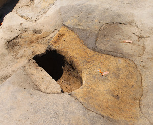 Excavated posthole surrounded by additional outlined features