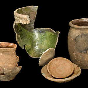 Four mended earthenware vessels