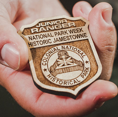 photo of NPS Junior Ranger badge held in a person's hand