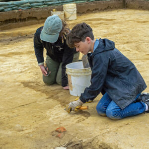 A former kids camp attendee returns to help Archaeological Field Technician Ren Willis excavate the north field.