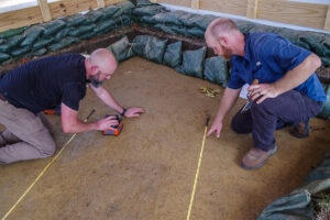 GSSI's Peter Leach and Director of Archaeology Sean Romo conduct a ground penetrating radar (GPR) survey of one of the burials.