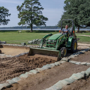 Senior Staff Archaeologist Anna Shackelford backfills part of the excavations just south of the Archaearium. Only the sections involved in the upcoming burial excavations were left open.