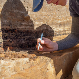 Staff Archaeologist Natalie Reid excavates an iron artifact found in the 1608 ditch.