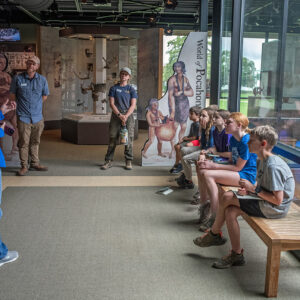 Director of the Archaearium Museum and archaeologist Jamie May gives a tour of the museum to Kids Camp attendees.