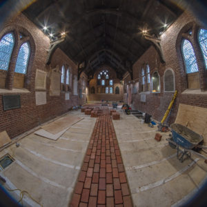 Fisheye view of installation of the new floor in the Memorial Church showing middle brick strip