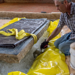 Conservator examines Knight's Tombstone