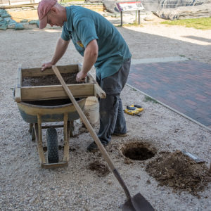 Senior Staff Archaeologist Sean Romo screens dirt from a shovel test dug to install lights around the Church Tower