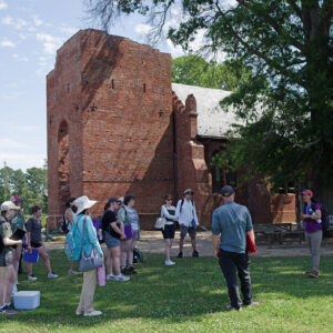 Senior Staff Archaeologists Sean Romo and Mary Anna Hartley give an archaeological tour of Jamestown to the field school students.