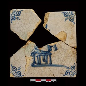 Tile with central figure of a seated man, likely a craftsman