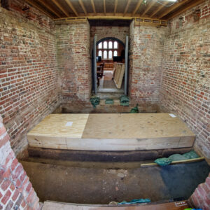 The wooden case is installed to protect the 1617 church foundations during the concrete pour for the glass floor.