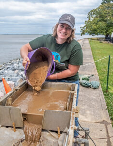 Curator Leah Stricker uses the flotation machine to process a soil sample.