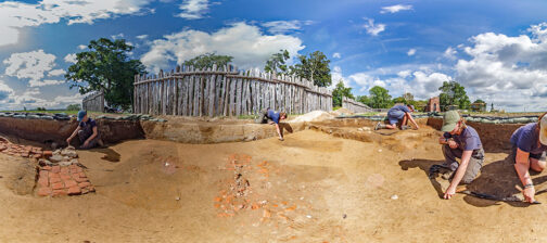 The Jamestown Rediscovery team prepares the area of the 1607 burial ground where this year's burial excavations will take place. The three dark rectangles are the top of the grave shafts. The brick scatter at center may be a robbed hearth from a later building. The brick and cobblestone feature at left is a chimney base for a fort-period building that paralleled the west palisade wall and was approximately 92 feet long.