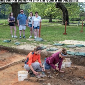 Archaeologists excavating with visitors in the background