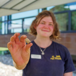 Archaeological Field Technician Eleanor Robb holds the Minié ball she found while excavating just south of the Archaearium. This is only the seventh example in the Jamestown Rediscovery collection.