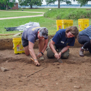 Field school student Kristin Grossi, Staff Archaeologist Caitlin Delmas, Archaeological Field Technician Eleanor Robb, and field school student Kenna Abrams at work south of the Archaearium.