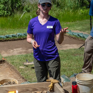 Field School student Ren Willis shares the findings at the clay borrow pit excavations with staff and visitors.