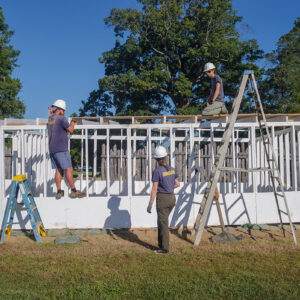 Archaeological Field Technician Josh Barber, Staff Archaeologist Ren Willis, and Senior Staff Archaeologist Anna Shackelford build a roof for the burial structure at the 1607 Burial Ground.