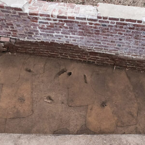 A 2019 photo of graves discovered just east of the church wall. This pattern is similar to what the archaeologists have found along the western bounds of the excavations adjacent to the ticketing tent.