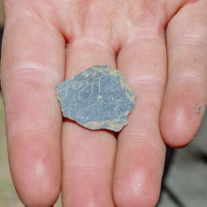 A small slate fragment bearing writing found in the excavations south of the Archaearium.