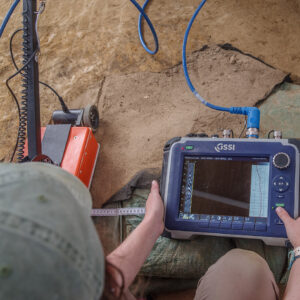 Staff Archaeologist Ren Willis monitors the GPR results of one of the burials in the 1607 Burial Ground.