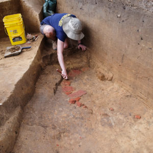 Staff Archaeologist Natalie Reid excavates the well found in the Confederate Moat.