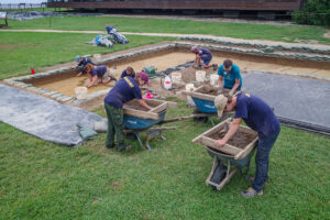 Archaeologists, interns, and volunteers at work at the excavations south of the Archaearium