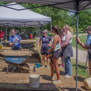 Field school student Grace Blondin-Kissel shares the artifacts found in her excavation square during the weekly walkabout.