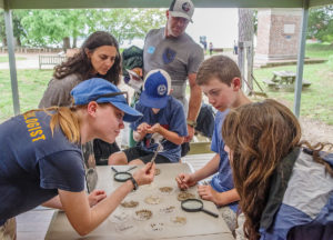 Staff Archaeologist Natalie Reid engages visitors in the Ed Shed.