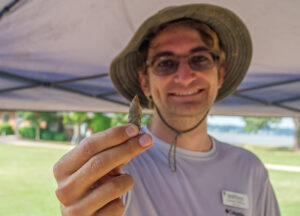 Field school student Connor DeWall holds a projectile point he found just south of the Archaearium.
