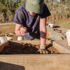Archaeological Field Technician Ren Willis sorts for artifacts at the clay borrow pit.