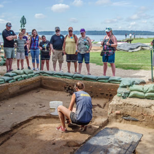 Site Supervisor Anna Shackelford describes the north Church Tower excavations to visitors.