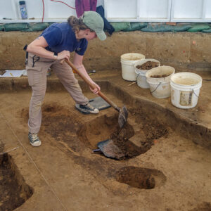 Staff Archaeologist Ren Willis removes a feature cutting JR1454. It needed to be removed before excavations of the burial could continue.
