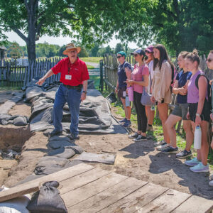 Archaeologist Henry Miller gives a tour of St. Mary's City excavations to the field school students and staff.
