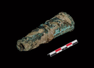 A copper-alloy bandolier bottle with portions of a surviving leather covering