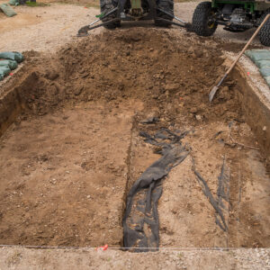 Filter fabric marks the boundary between previous excavations beneath and backfill above.