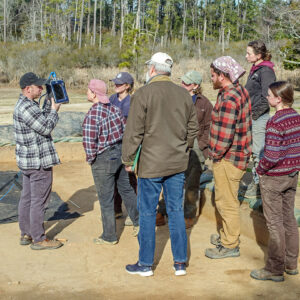 Director of Archaeology Sean Romo discusses GPR data from the cellar excavations with staff.