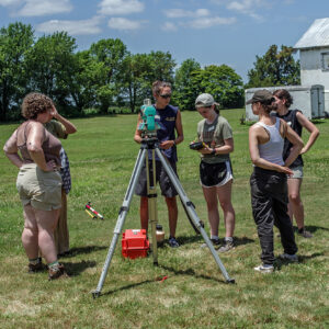 Site Supervisor Anna Shackelford instructs field school students in the use of surveying equipment at Bacon's Castle.