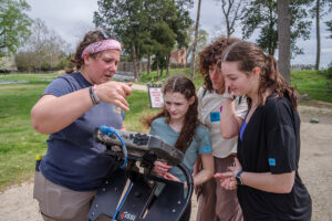 Visitors learn how to interpret a ground-penetrating radar survey from Archaeological Field Technician Hannah Barch.