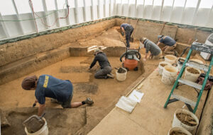 The team at work slowly scraping away at the layers above the human remains in the 1607 Burial Ground