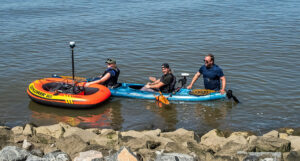 Archaeological Field Technician Eleanor Robb, Staff Archaeologist Gabriel Brown, and TerraSearch Geophysical's Dr. David Leslie prepare for a 200MHz GPR survey of portions of the James River.