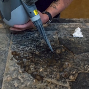 Conservator works on Knight's Tombstone