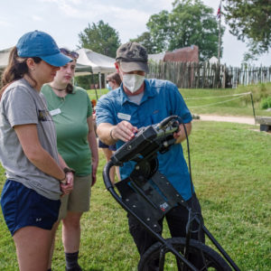Senior Staff Archaeologist Sean Romo teaches Field School students how to operate the GPR.