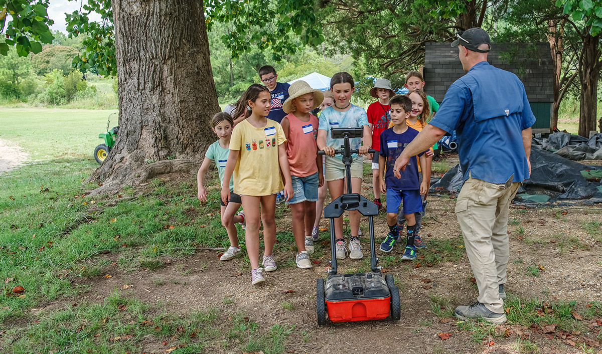 Senior Staff Archaeologist Sean Romo teaches campers how to use the ground-penetrating radar machine.