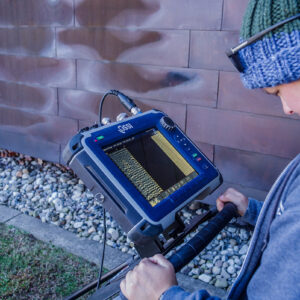 Staff Archaeologist Caitlin Delmas conducts a ground-penetrating radar (GPR) survey of the area just west of the Archaearium.