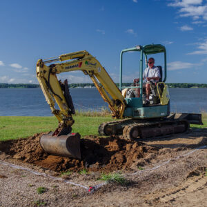 Contractor Tim Schmidt removes the top layers of the 1607 Burial Ground excavation site. The area was previously excavated about twenty years ago and the top layers are backfill from those excavations.