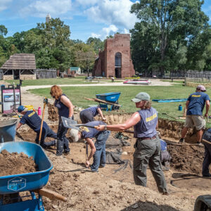 The archaeology team removes the backfill at the 1607 Burial Ground. The black filter fabric on the ground was placed there in the 2000s by archaeologists after completing their excavations to protect the archaeological resources underneath.