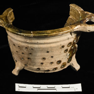 exterior of mended earthenware strainer with opposite handles