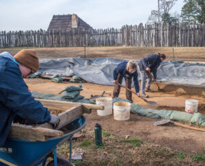 Staff Archaeologist Caitlin Delmas screens excavated soil for artifacts while Archaeological Field Technician Katie Griffith and Senior Staff Archaeologist Anna Shackelford dig in the cellar.